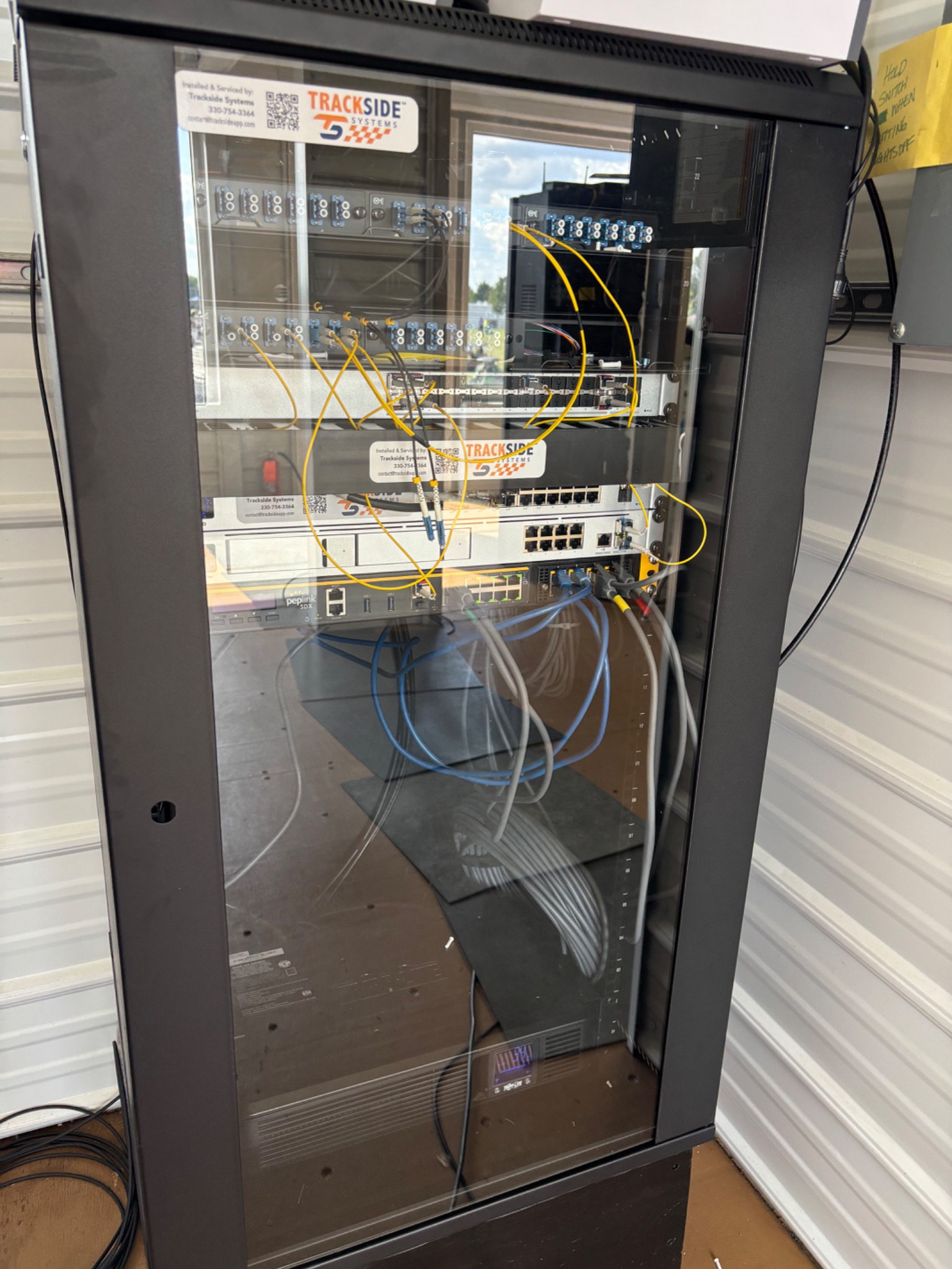 Trackside fiber and network equipment installed in a cabinet.