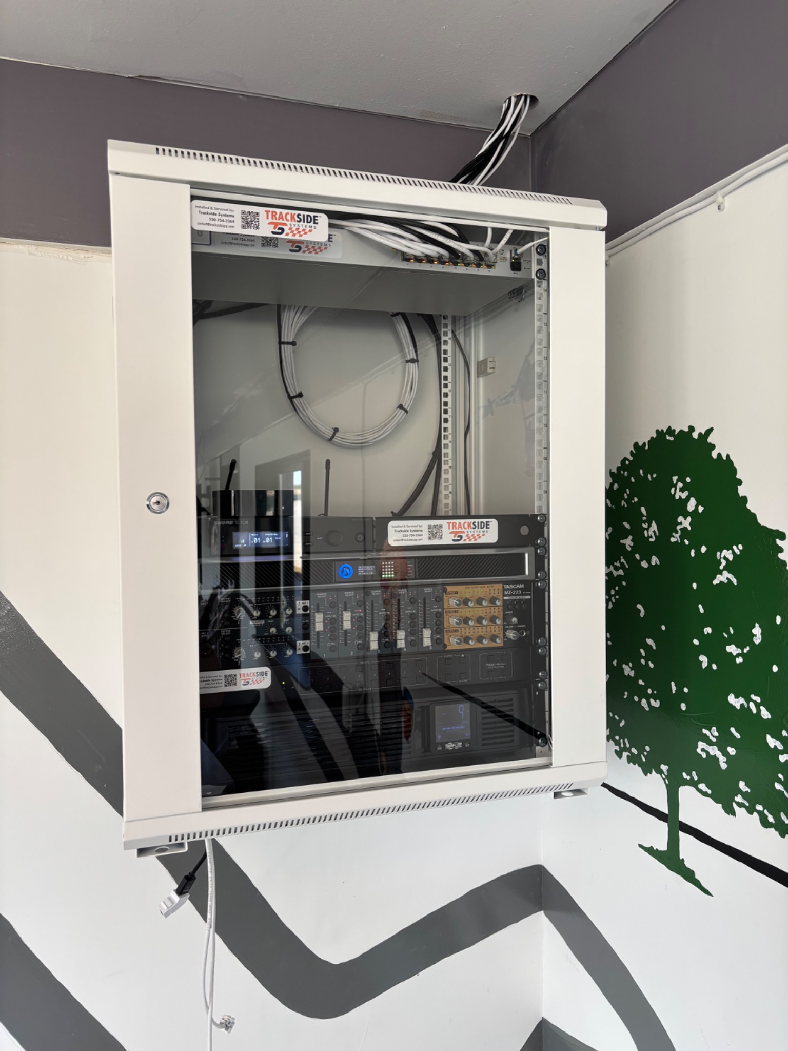 Trackside network and audio equipment installed in a wall cabinet.